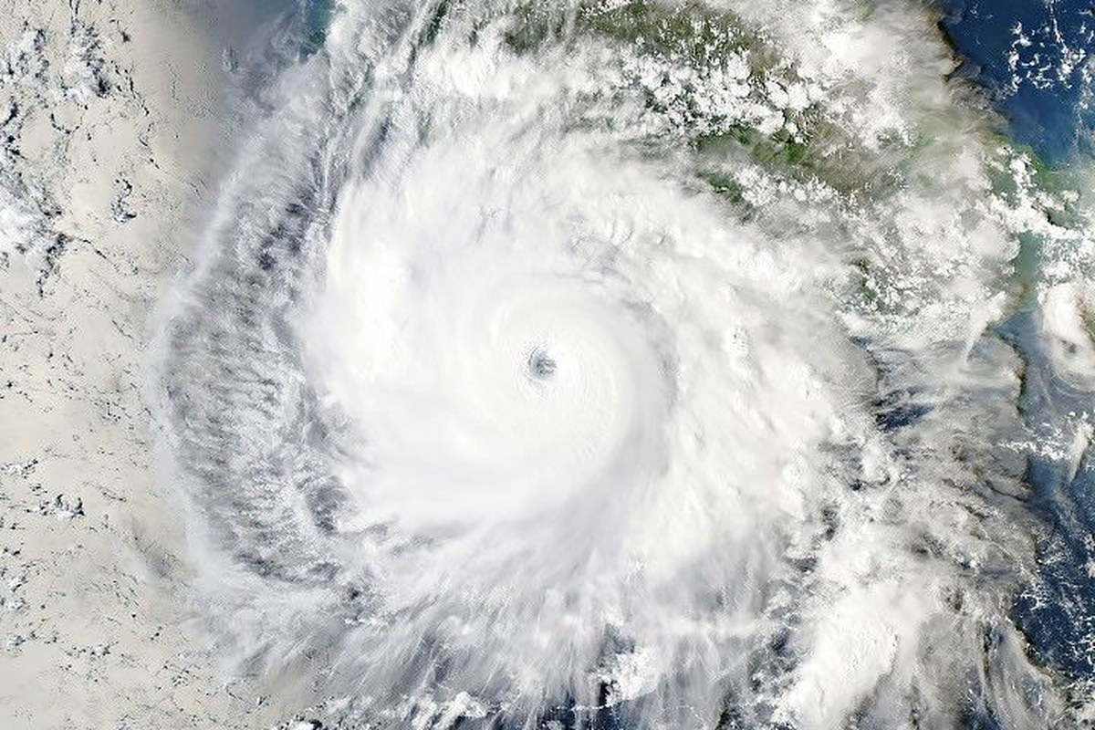 Hurricane Polo, with a well-defined eye, swirls over the Pacific Ocean off the coast of Mexico. The storm was positioned just south of Acapulco, with its outer cloud bands extending inland toward Mexico City.