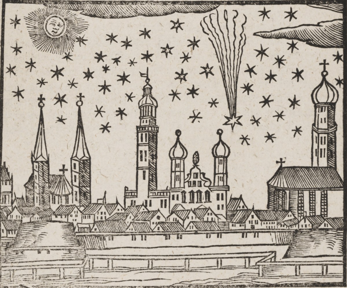 A black-and-white woodcut illustration depicts a cityscape with spires, domed towers, and gabled roofs along the bottom half of the frame. Above the town, a light-colored sky is filled with numerous black four- and five-pointed star shapes, a smiling sun face in the upper-left corner, and a star with a tall, vertical wavy trail on the right. Simple cross-hatch shading creates texture across the buildings, clouds, and wooden fence structure in the foreground.