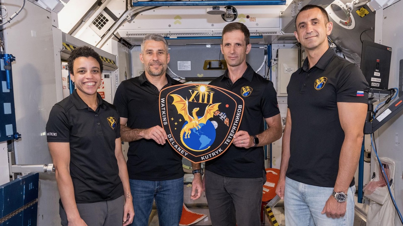 The four members of NASA’s SpaceX Crew-13 mission to the International Space Station display their mission plaque inside a training mockup of a space station module. From left: Commander Jessica Watkins and Pilot Luke Delaney, both from NASA, and Mission Specialists Joshua Kutryk of the Canadian Space Agency and Sergey Teteryatnikov of Roscosmos.