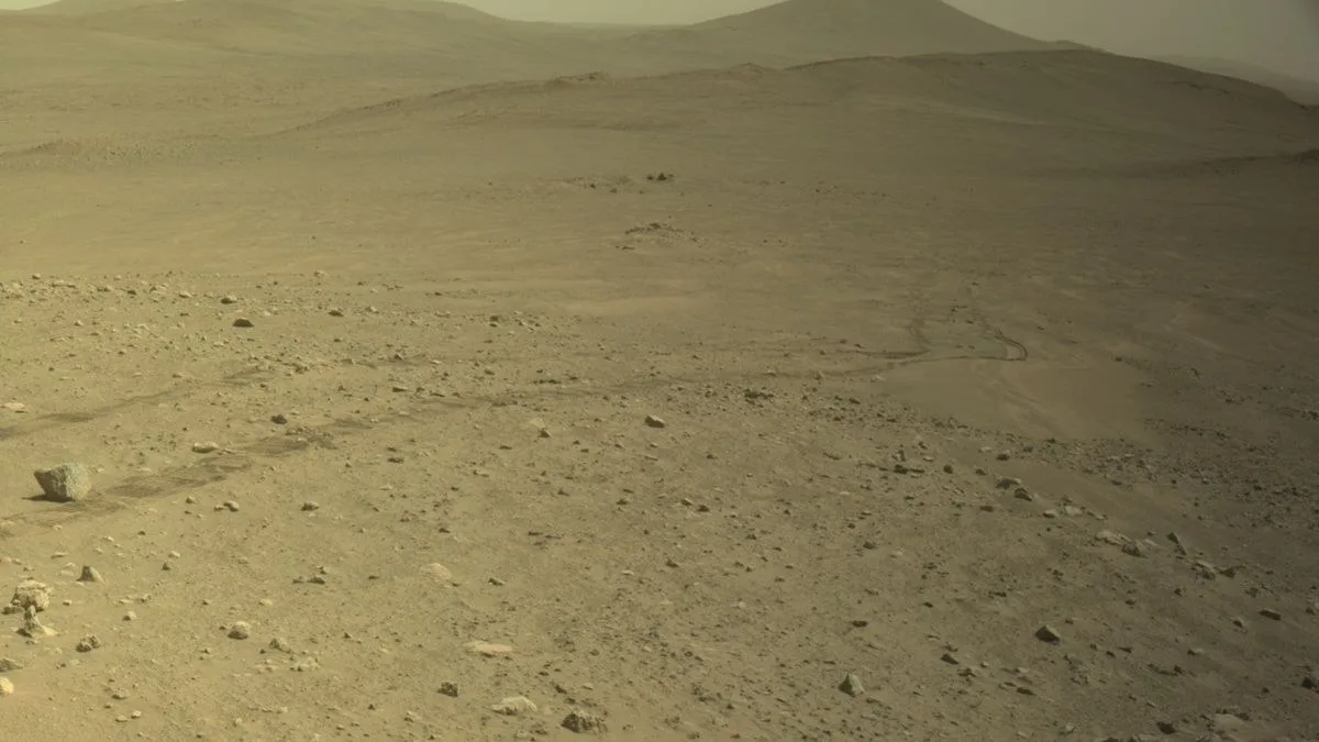 wheeled tracks in reddish orange soil