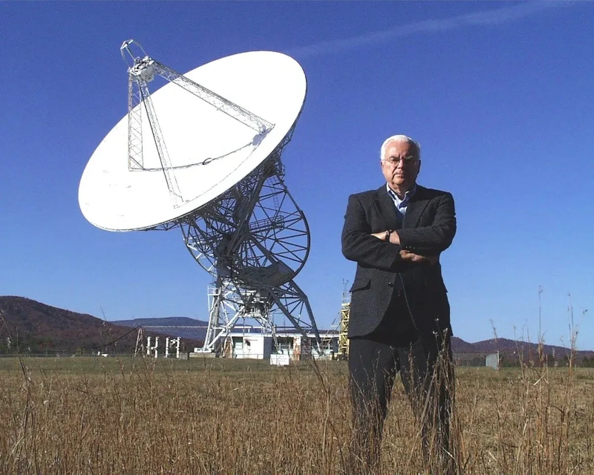 Cornell Professor and SETI pioneer Frank Drake standing in front of the 25-meter Howard E. Tatel Radio Telescope at the Green Bank Observatory. Credit: NRAO/AUI/NSF