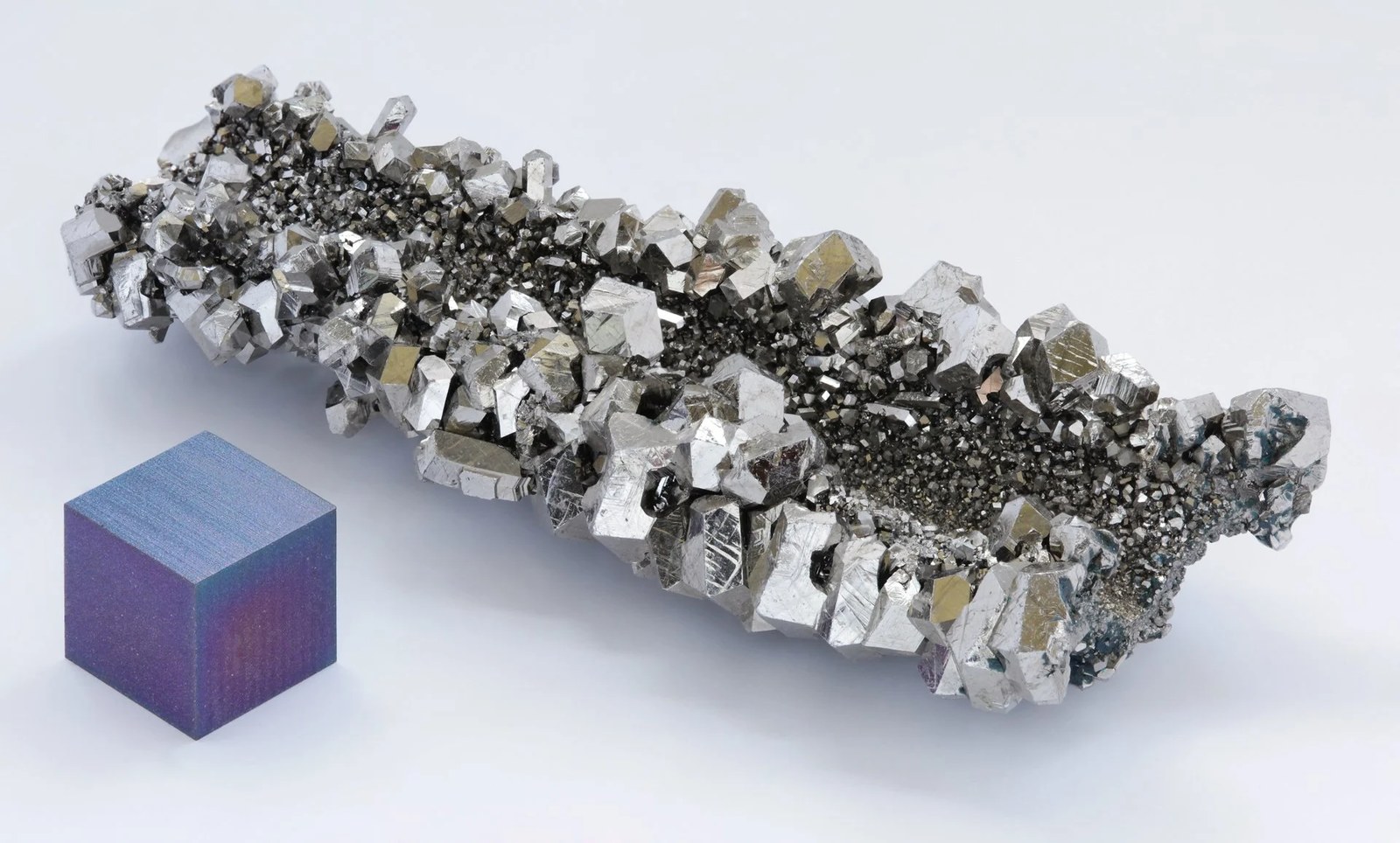 High purity (99.995 % = 4N5) niobium crystals, electrolytic made, as well as a high purity (99.95 % = 3N5) 1 cm3 anodized niobium cube for comparison. Credit: Wikipedia