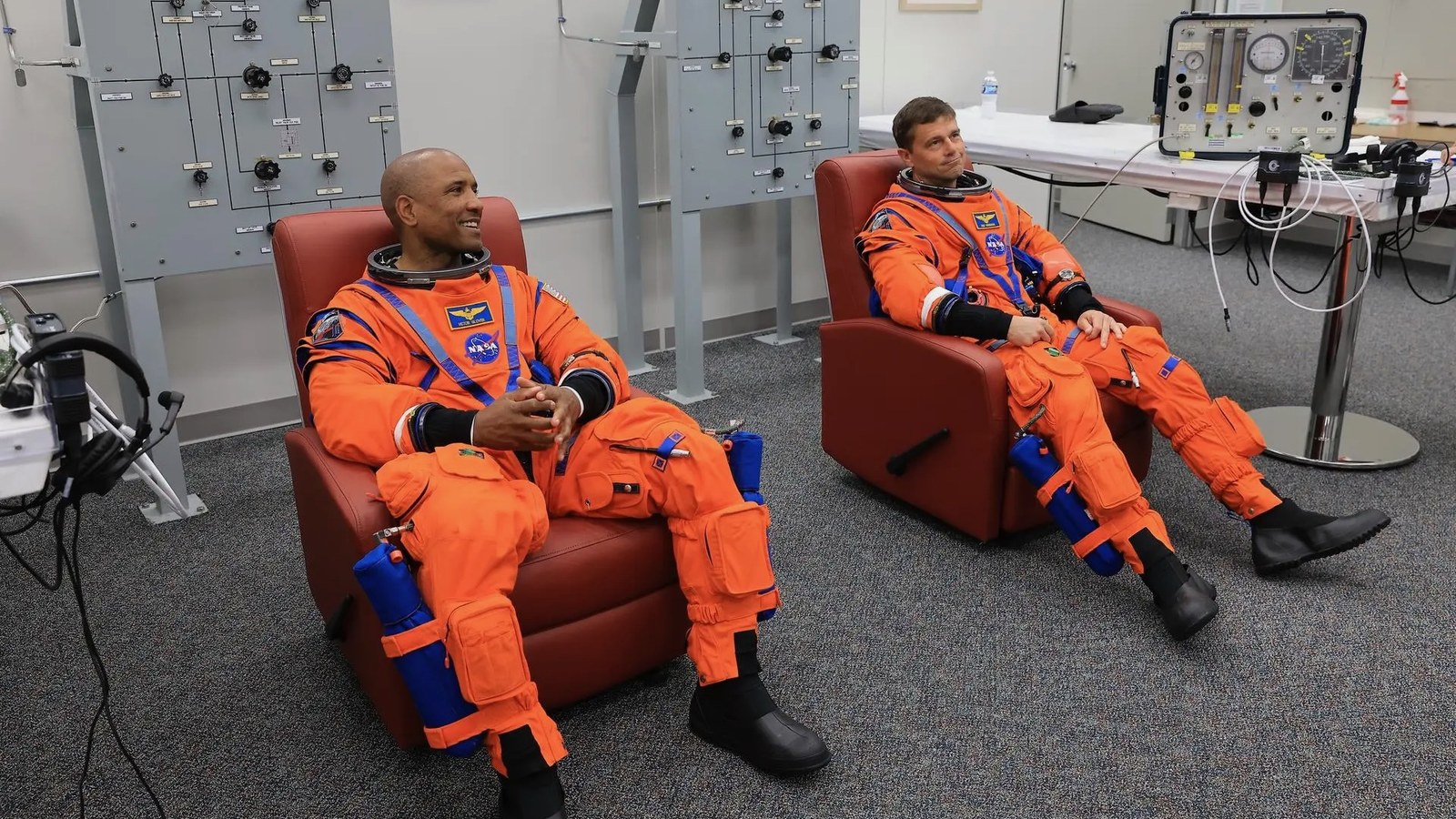 From left: NASA astronauts Victor Glover, Artemis II pilot, and Reid Wiseman, Artemis II commander, conduct leak checks on their spacesuits at NASA's Kennedy Space Center in Florida on April 1, 2026, ahead of the Artemis II launch.