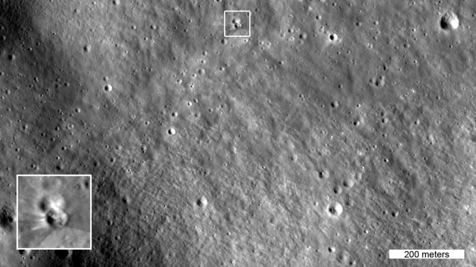 The box in this image highlights two small craters. The lower crater formed on Aug. 5, 2026 when a SpaceX Falcon 9 upper stage impacted the moon. The inset shows details of the new crater, enlarged three times. This image was captured by NASA’s Lunar Reconnaissance Orbiter on Aug. 11, 2026 as it passed over the site at an altitude of 56 miles (90 kilometers).