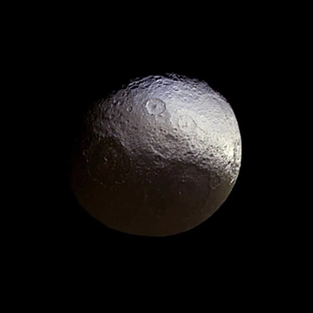 This image taken by the Cassini spacecraft shows what the two-tone surface of the moon Iapetus looks like without false color.