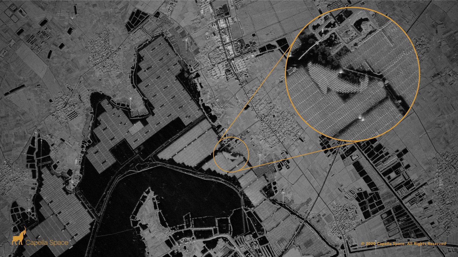 This SAR image shows a solar farm floating on top of the human-made Lake Tiangang in China. The fishery-solar hybrid photovoltaic power station covers approximately half of the lake’s surface and contrasts from the lake’s surface depicted by dark areas in the SAR image. A zoomed-in view shows the individual solar arrays on floating devices in the shape of a "fish."